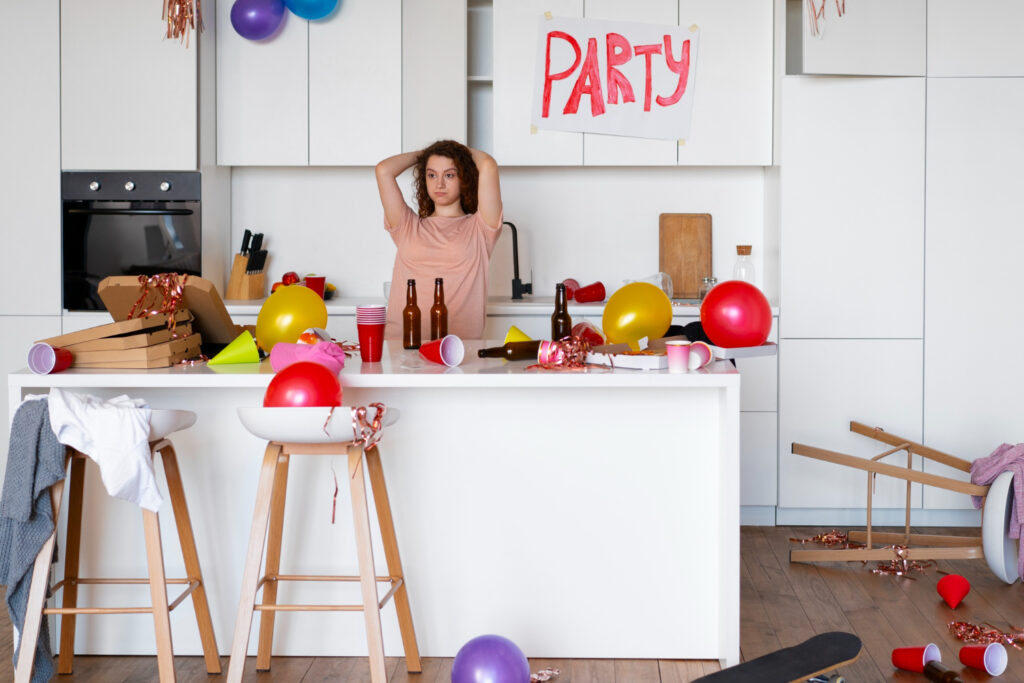 Uma cozinha limpa e organizada, com uma pessoa sorrindo ao fundo, simbolizando o fim da sujeira na cozinha.